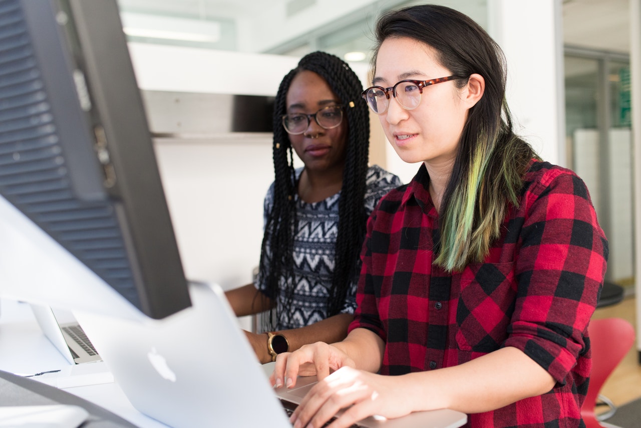 Two women working on a project on a computer